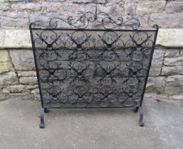 A heavy gauge decorative iron work fire guard, 83 cm (full height) x 82 cm full width