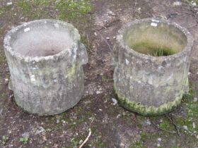 A pair of weathered cast composition stone garden planters in the form of tree stumps, 29cm high,