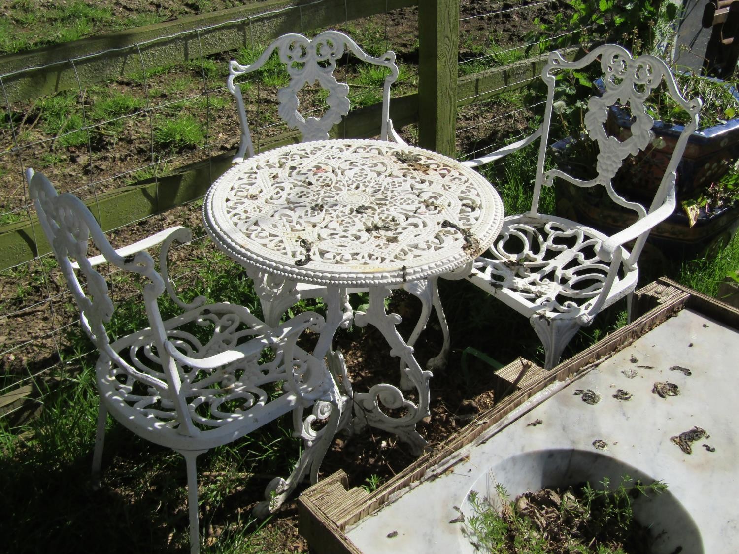 A small weathered cast iron terrace table with decorative pierced circular top raised on scrolled - Image 2 of 2