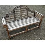 A weathered stained Lutyens style three seat garden bench 166 cm long