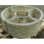 A Sandford cast composition stone four sectional mock stock wall effect planter forming a circle, 90