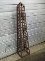 A weathered metal strapwork garden obelisk of square tapered form approx 150 cm high x 30 cm