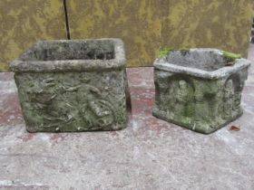 Two medieval style weathered cast composition stone garden planters with relief detail, one of