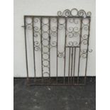 An old weathered ironwork garden gate with scrolling detail, 104cm high, 96cm wide
