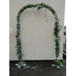 A painted square tubular steel framed wedding arch with trailing artificial ivy and floral detail,