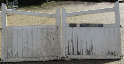 A pair of painted wooden entrance gates with sloping chamfered rails and through jointed