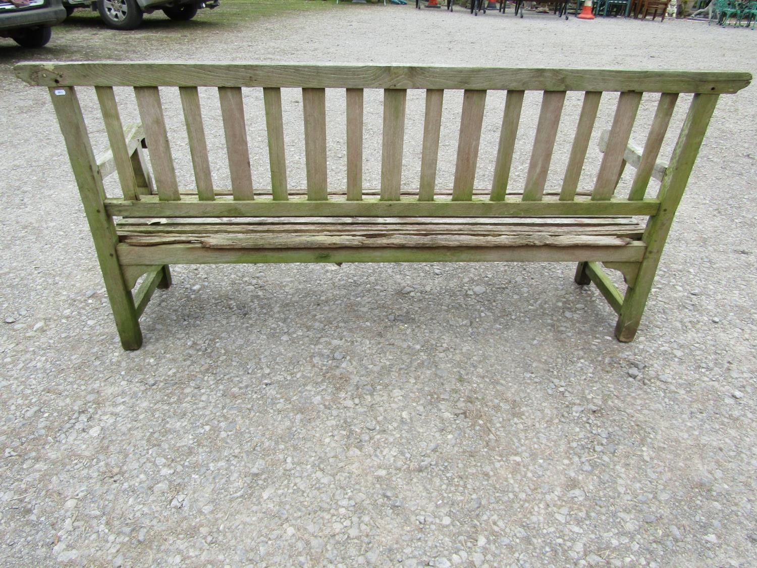 A well weathered teak garden bench with slatted seat and back and open scrolled arms, 198 cm long ( - Image 3 of 7