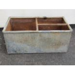 A rectangular galvanised steel water trough with rounded rim with simple bar division 40 cm high x