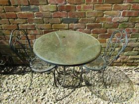 A circular ironwork 3 piece garden terrace set, together with a smaller circular top tale and single