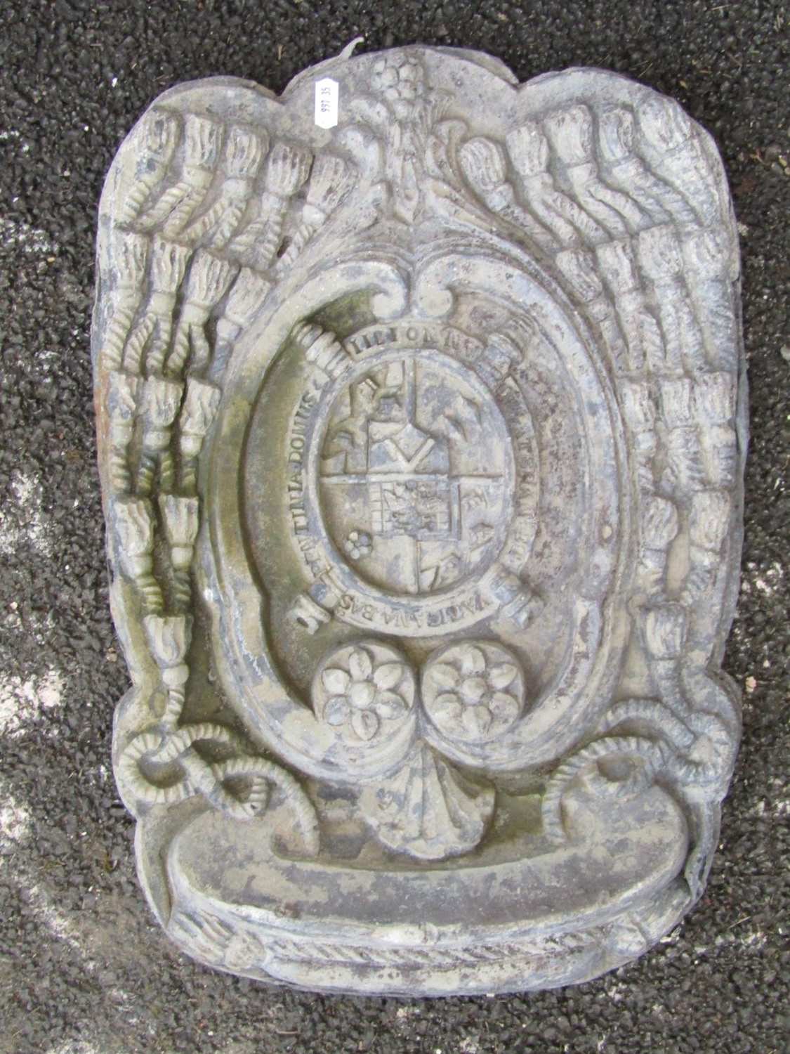 A heavy lead armorial panel, with central heraldic shield and devices, 50 x 33cm.