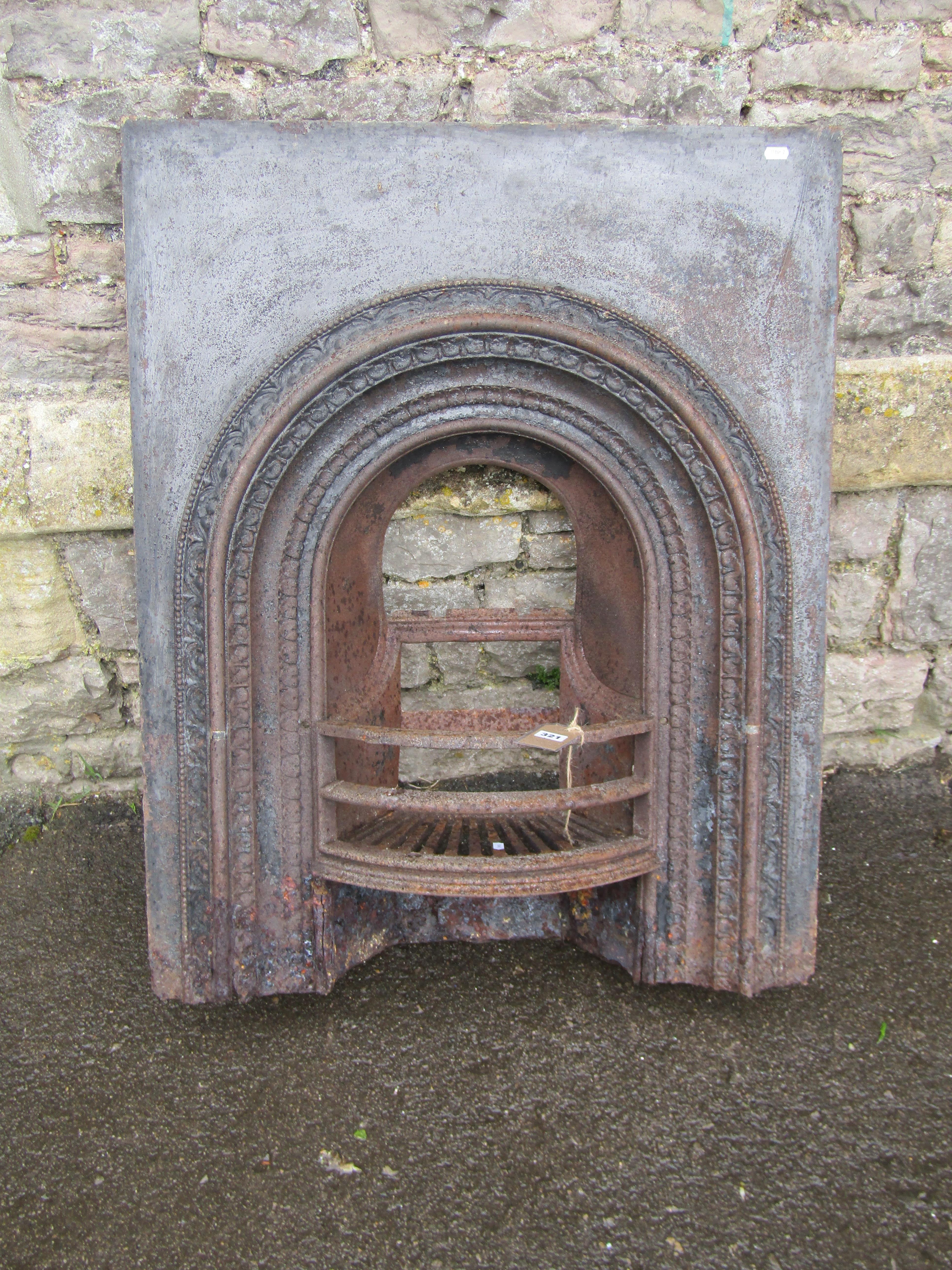 A 19th century cast iron fire insert, the bow fronted basket with arched surround together with