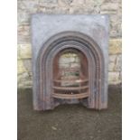 A 19th century cast iron fire insert, the bow fronted basket with arched surround together with