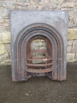 A 19th century cast iron fire insert, the bow fronted basket with arched surround together with