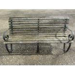 A heavy gauge park/garden bench with weathered teak slatted seat raised on heavy gauge sprung