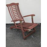 A stained hardwood folding steamer type chair with slatted seat and back
