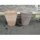 Eight contemporary terracotta planters of circular form (two sizes) the largest 45cm high x 50cm