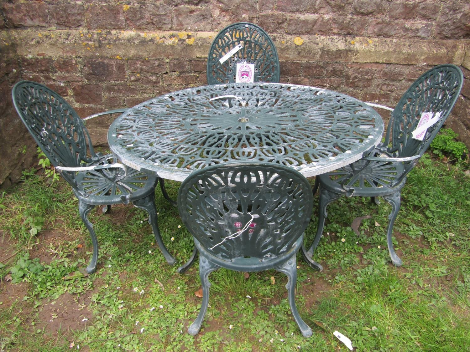 A heavy gauge green painted cast alloy five piece garden terrace set comprising oval two tier