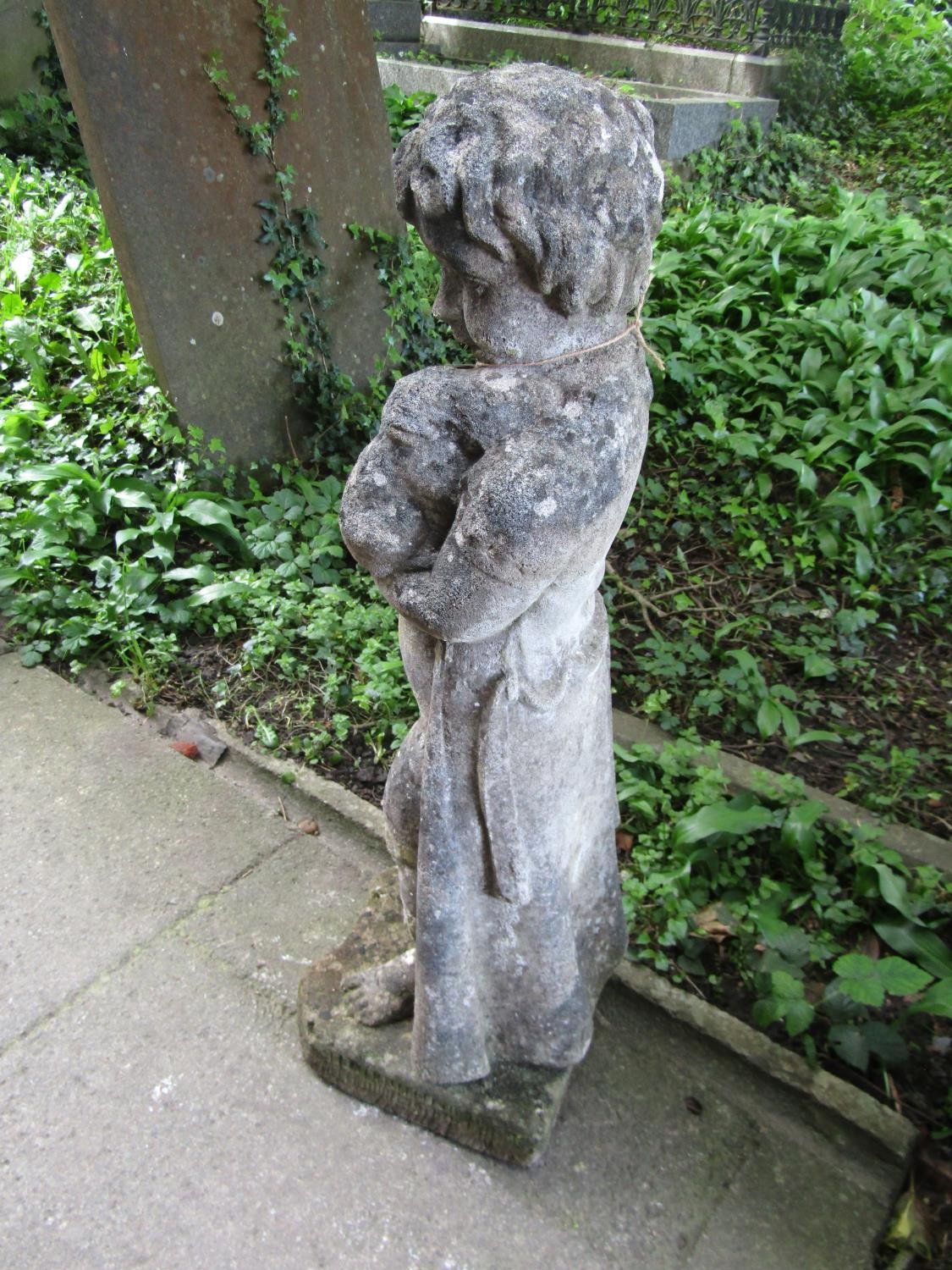 A weathered cast composition stone garden ornament in the form of a boy wearing a long trench coat - Image 4 of 4