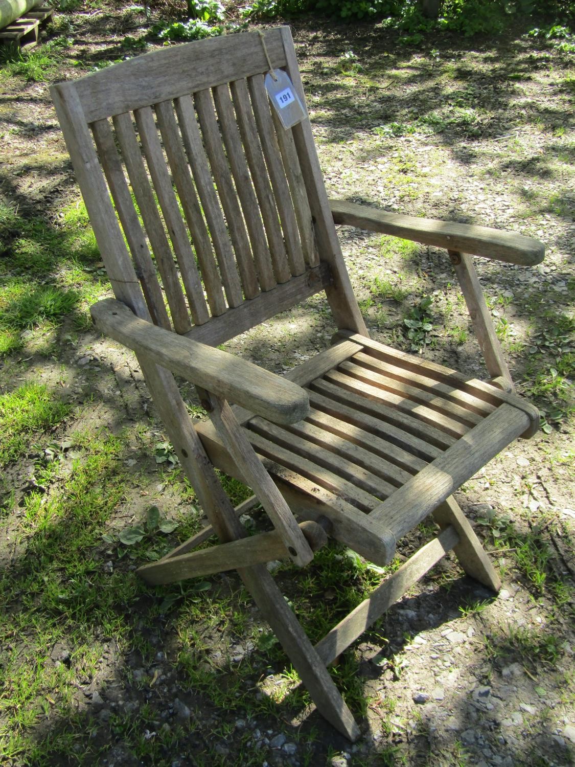 A set of four weathered teak folding garden armchairs with slender slatted seats and backs (af)