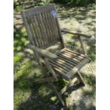 A set of four weathered teak folding garden armchairs with slender slatted seats and backs (af)