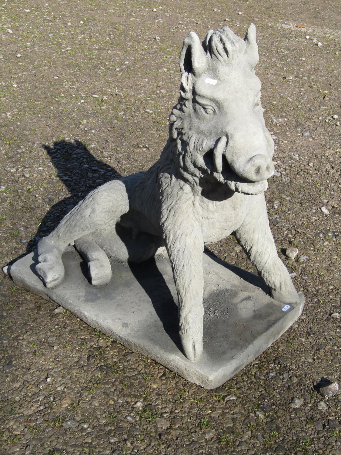 A life size cast composition stone garden ornament/study of a seated wild boar set on a - Image 2 of 5