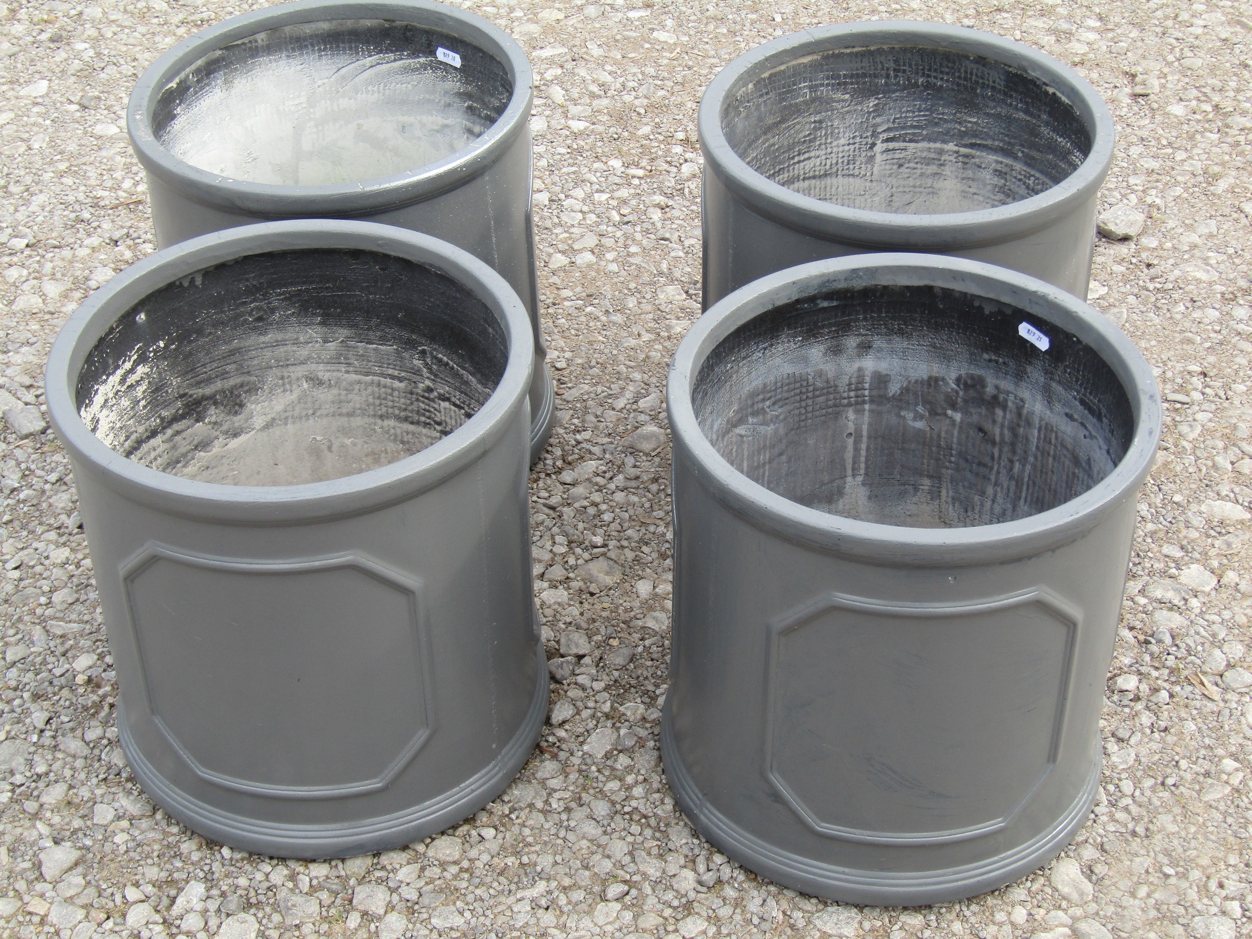 Four cylindrical fibre glass to simulate lead garden planters with repeating panels, 32 cm high x 32