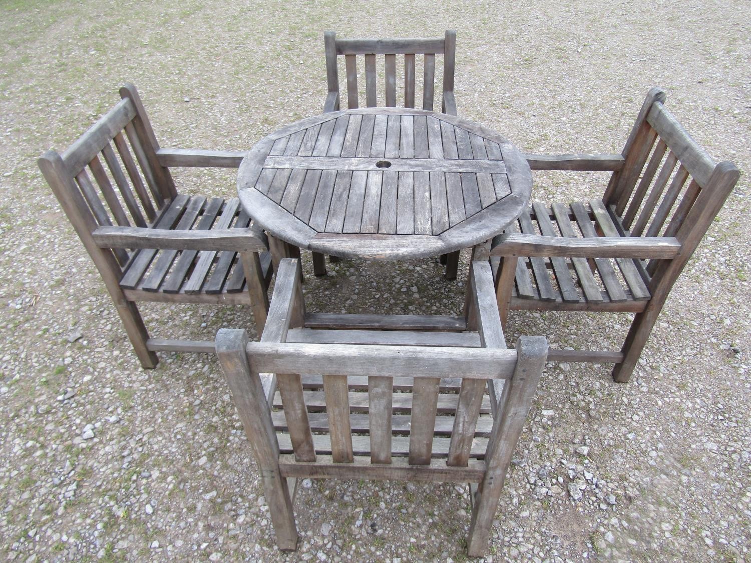 A weathered circular teak table and four associated armchairs (5) - Image 2 of 8