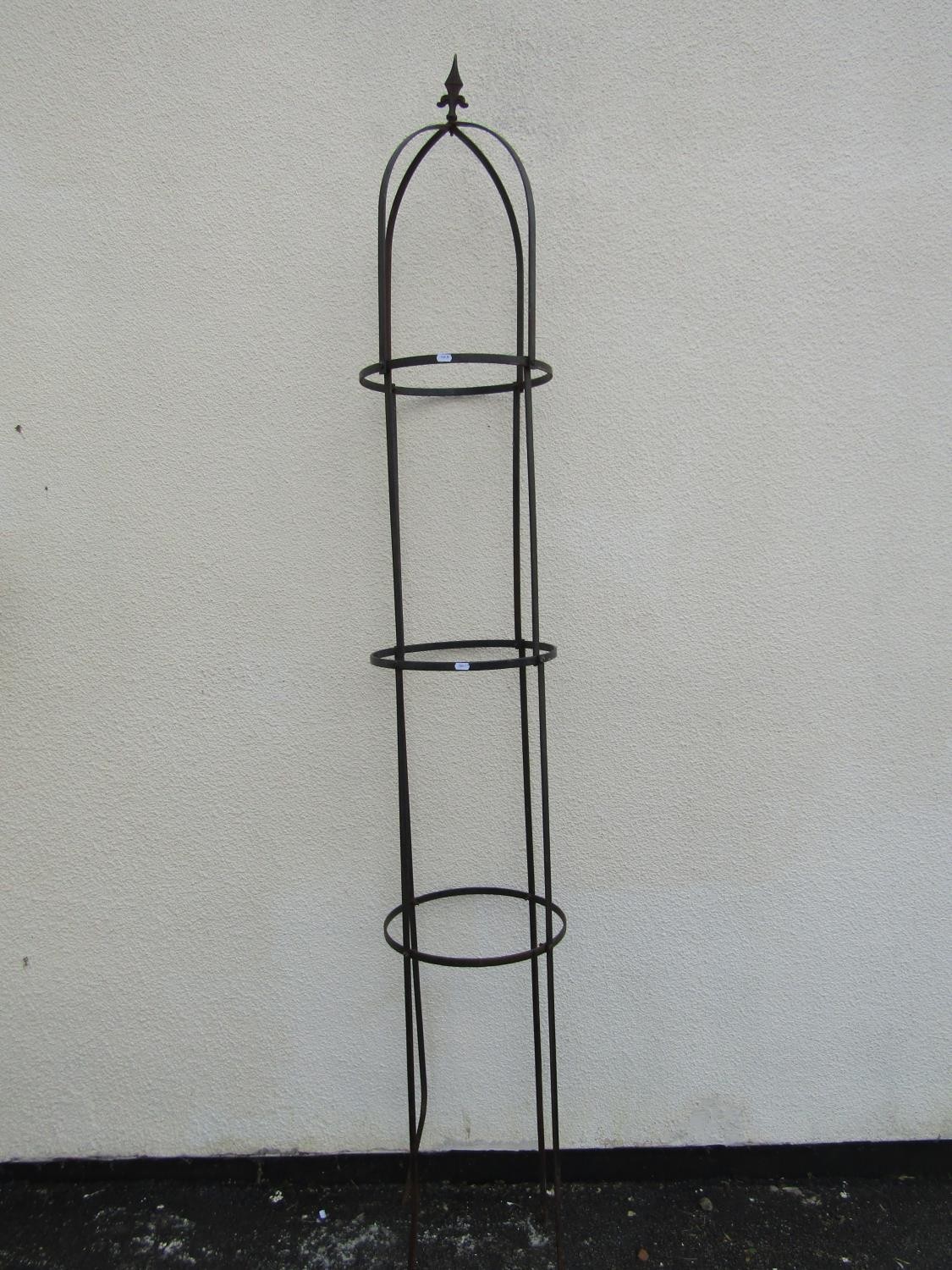 A painted steel strap work garden obelisk of cylindrical and domed form with spear head finial, 37