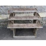 A small weathered oak plant stand on three stepped tiers with slatted framework 70 cm high x 86 cm