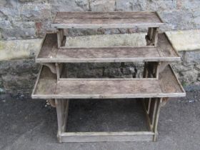 A small weathered oak plant stand on three stepped tiers with slatted framework 70 cm high x 86 cm