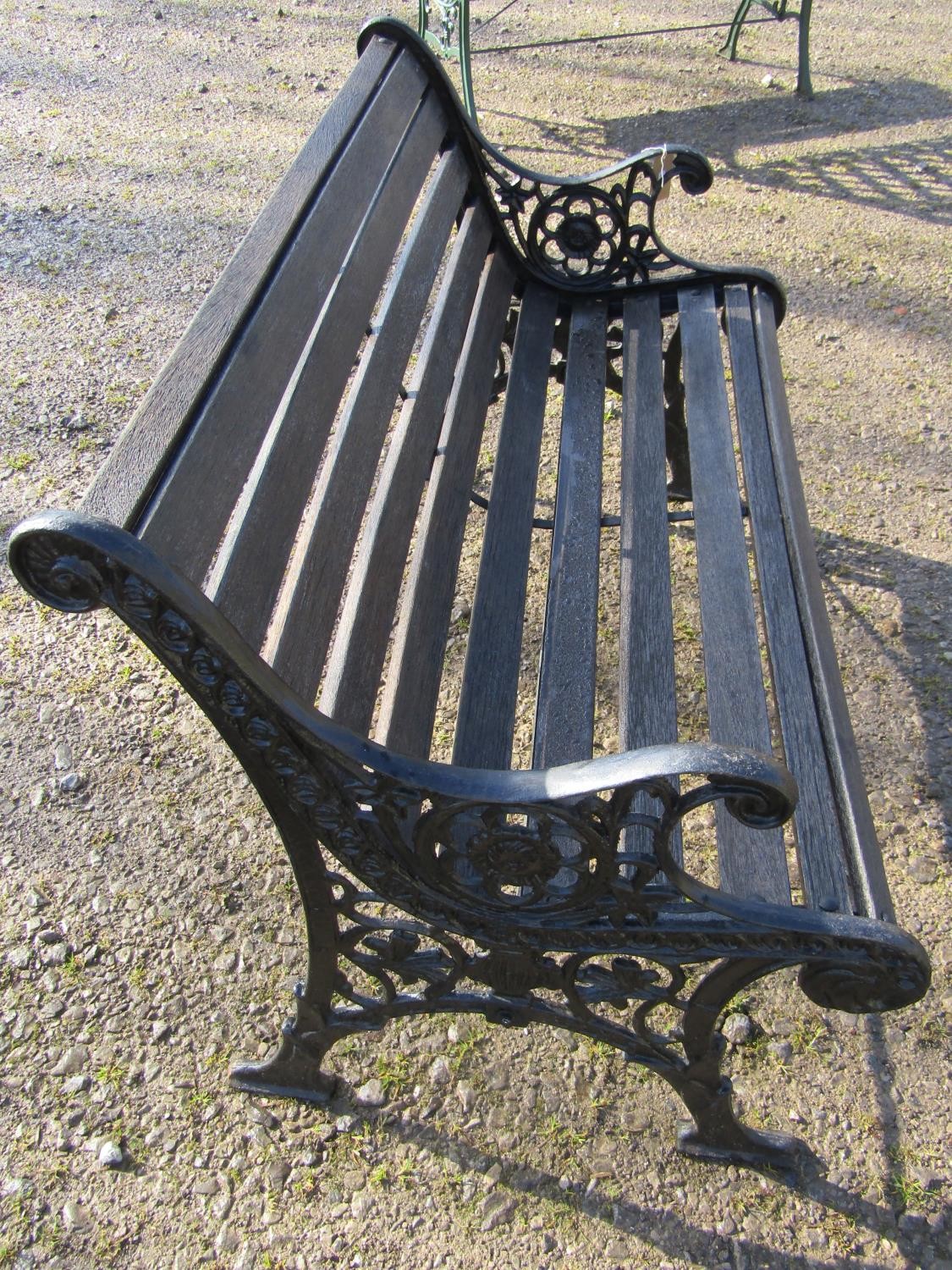 A two seat garden bench with stained wooden slatted seat raised on decorative pierced and scrolled - Image 2 of 4