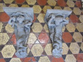 A pair of cast composition stone corbels with mermaid and merman detail, 52 cm high x 31 cm wide