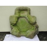 A cast to simulate rough hewn weathered stone water feature 86 cm x 80 cm approximately