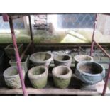A collection of cast composition stone planters, various designs and sizes, together with two