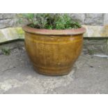A glazed circular planter with repeating dragon detail, 38 cm high x 50 cm diameter approximately