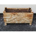 A small decorative rectangular weathered cast iron trough with classical swag detail, 22 cm high x