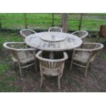 A good quality large weathered (silvered teak) circular garden table with slatted panelled top and