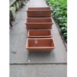 Seven rectangular terracotta flower troughs of varying size and slight variant in design, the larger