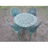 A weathered green painted cast aluminium five piece garden terrace set with decorative pierced and