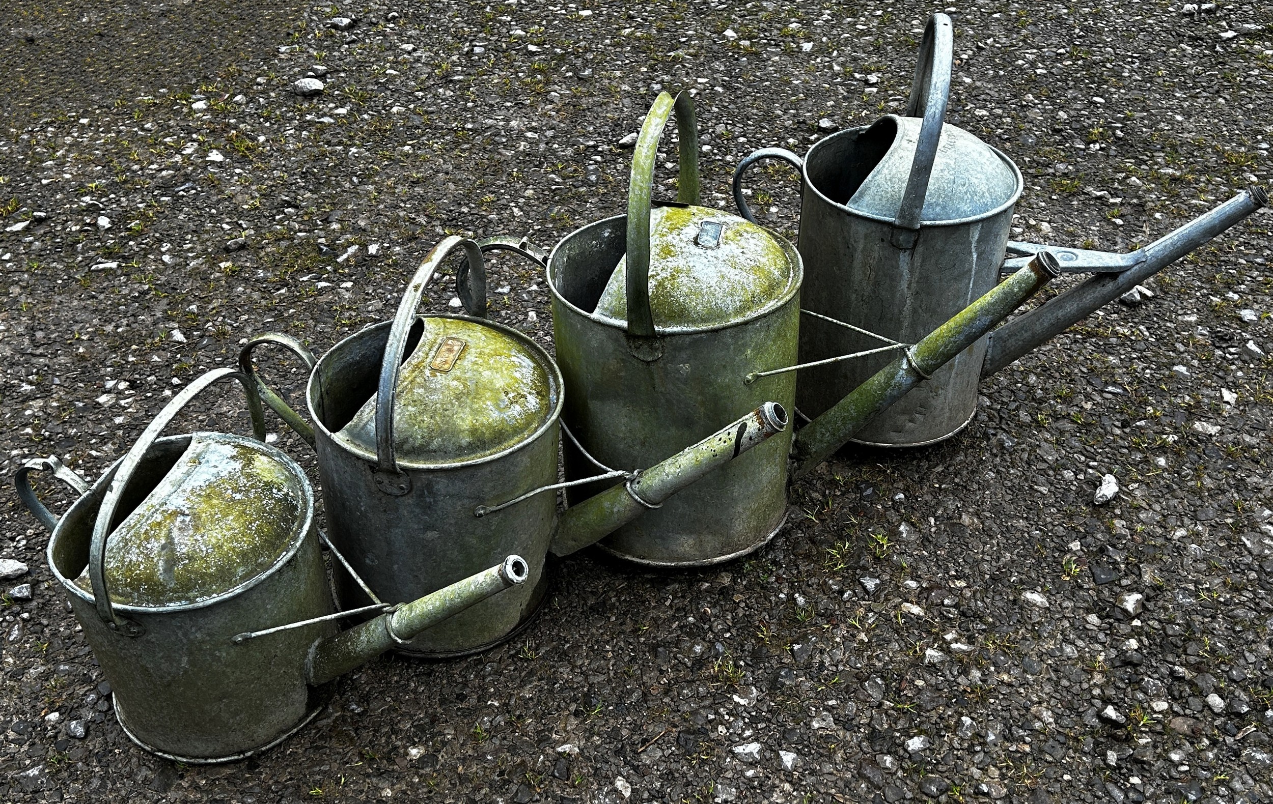 Four varying vintage galvanised watering cans (4)