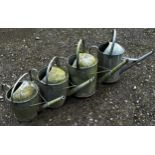 Four varying vintage galvanised watering cans (4)