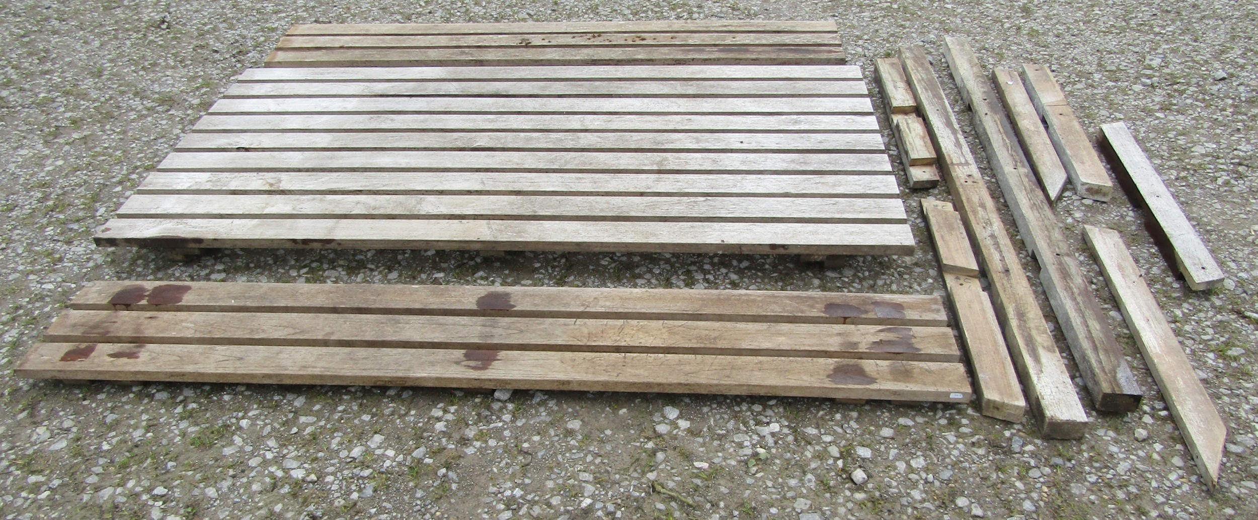 A good quality heavy gauge weathered teak picnic bench of rectangular form with slatted top and side