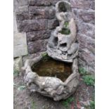 A weathered cast composition stone garden water feature with Otter detail, approx 86cm high