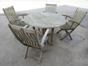 A Canterbury Collection weathered teak circular folding gateleg garden table and four matching