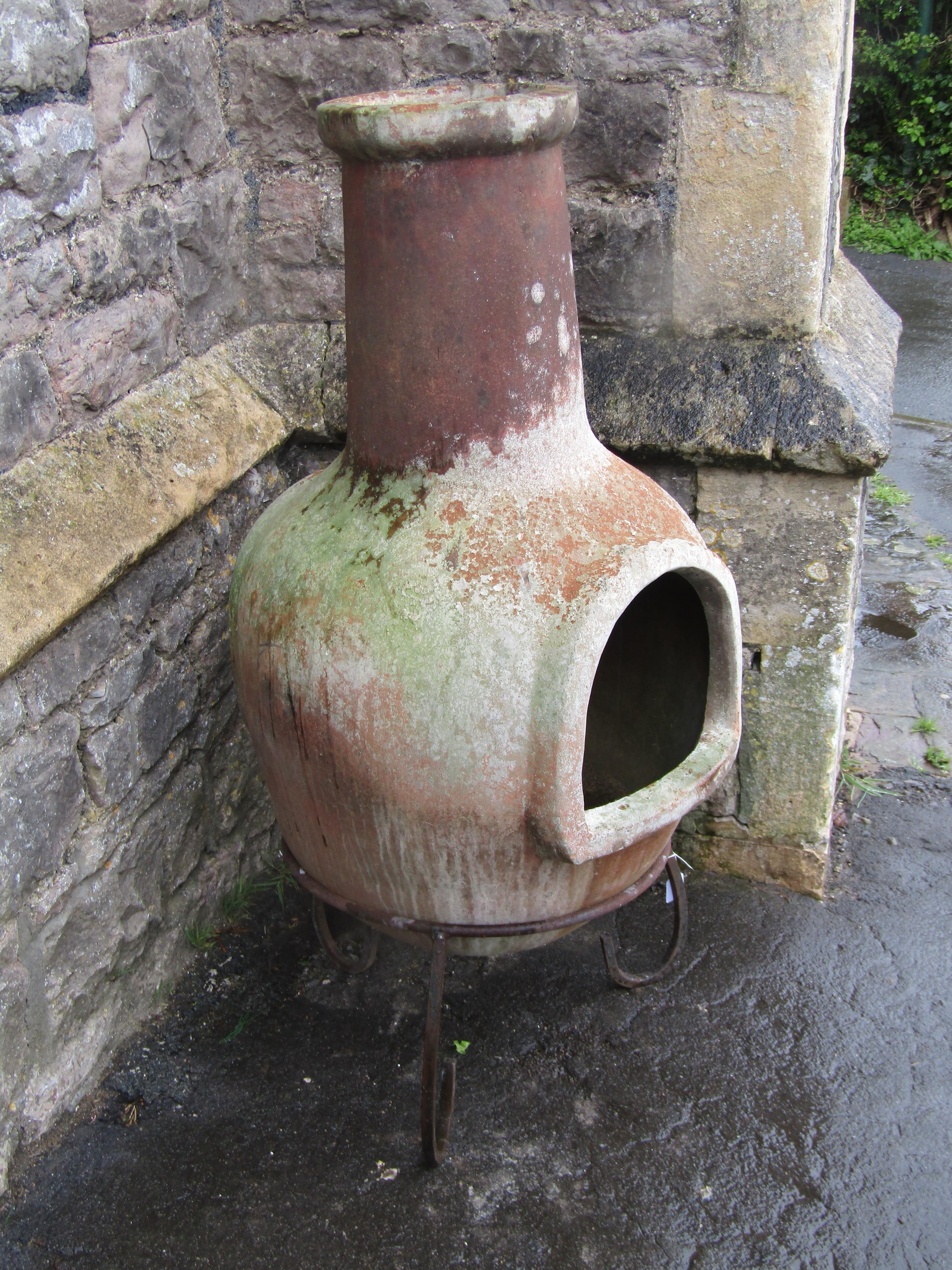 A large weathered clay chimenea raised on a simple steel stand, 107 cm high - Image 2 of 3