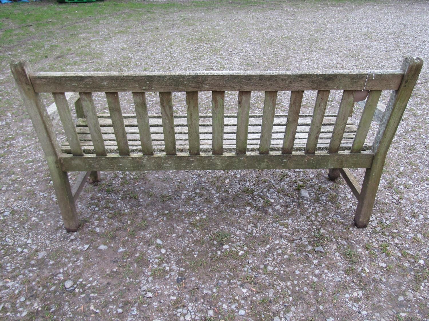 A weathered teak Tiger Trading three seat traditional garden bench with slatted seat and back, 153cm - Image 4 of 5