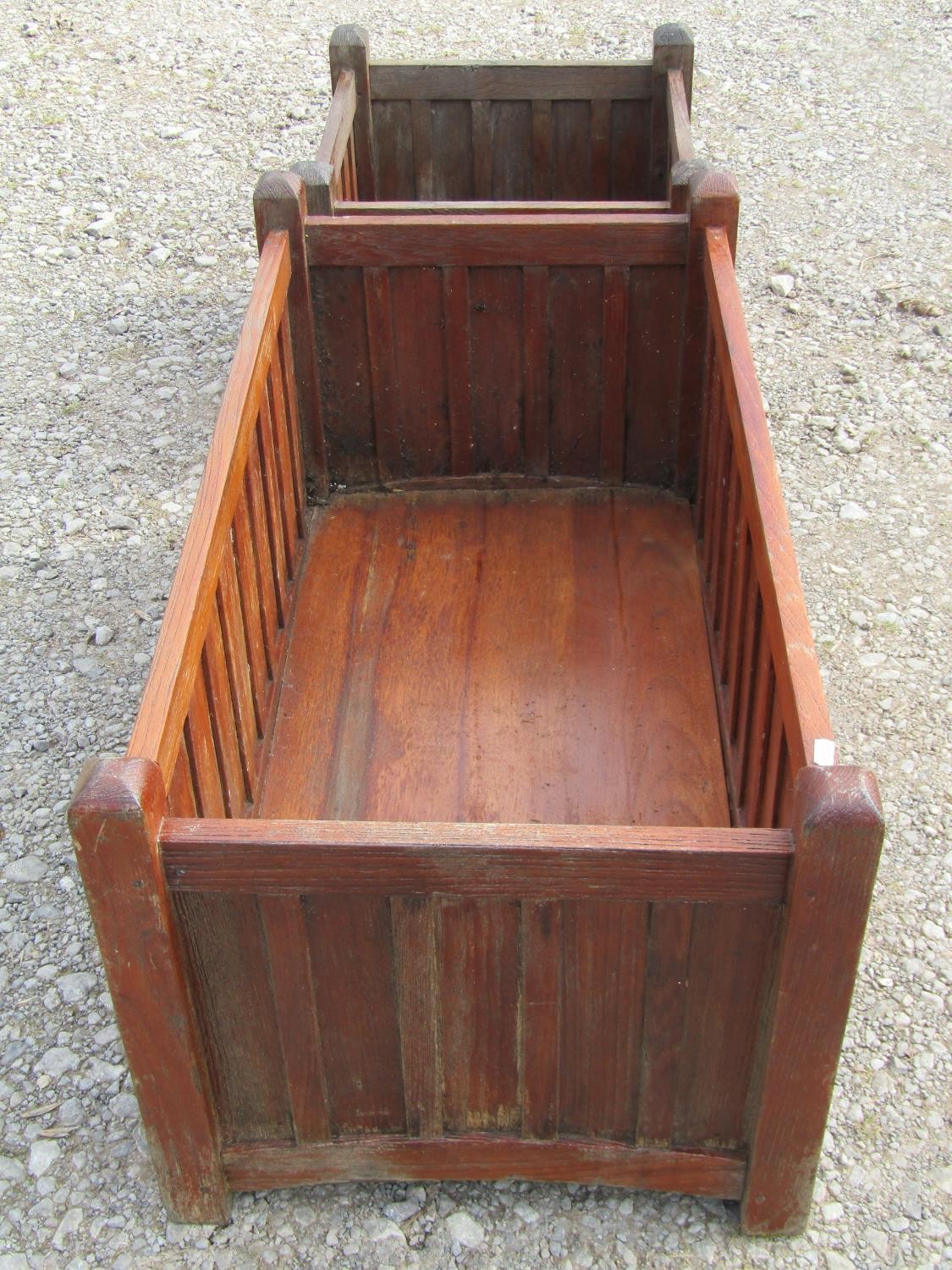 A pair of stained and weathered teak garden planters with facetted square cut supports and slatted - Image 2 of 7