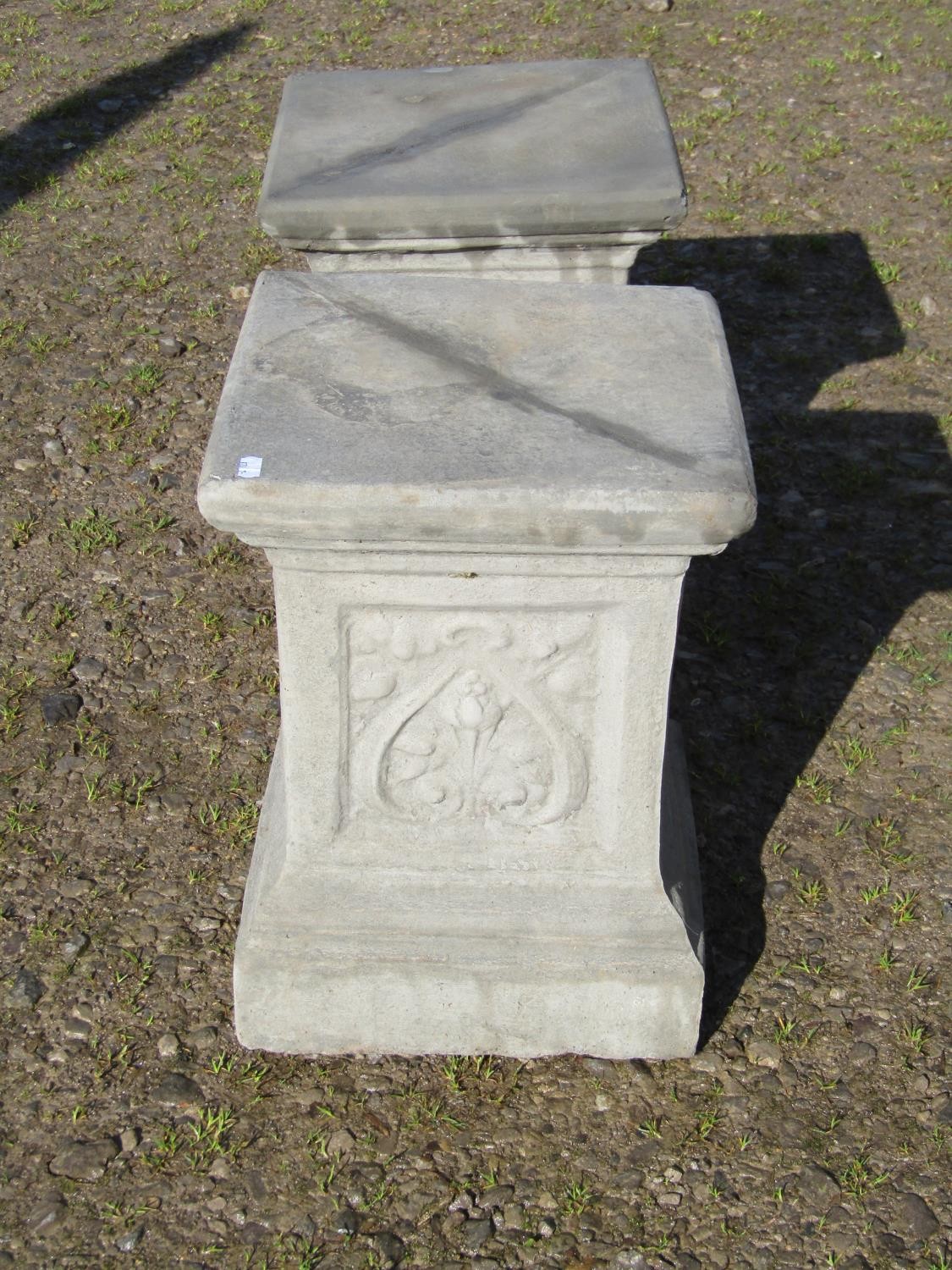 A pair of cast composition stone square cut and stepped pedestals, with repeating foliate panels, - Image 3 of 3