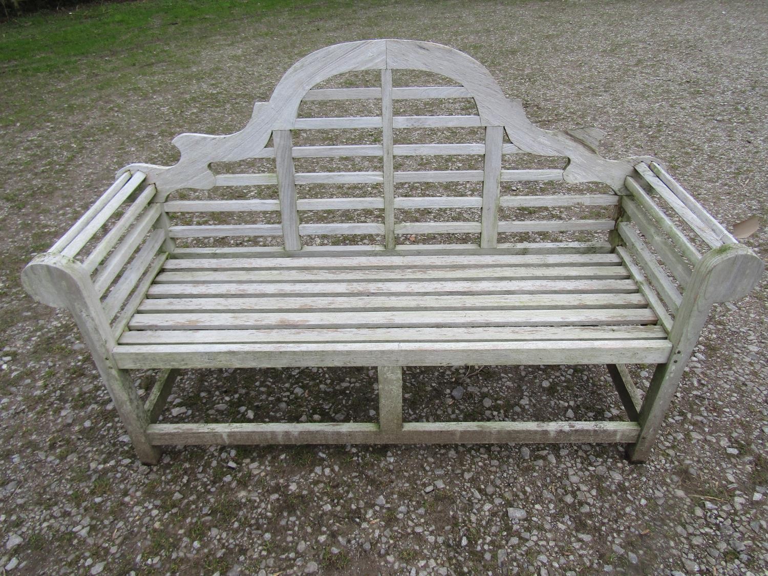 A weathered teakwood Lutyens style three seat garden bench, 167cm wide