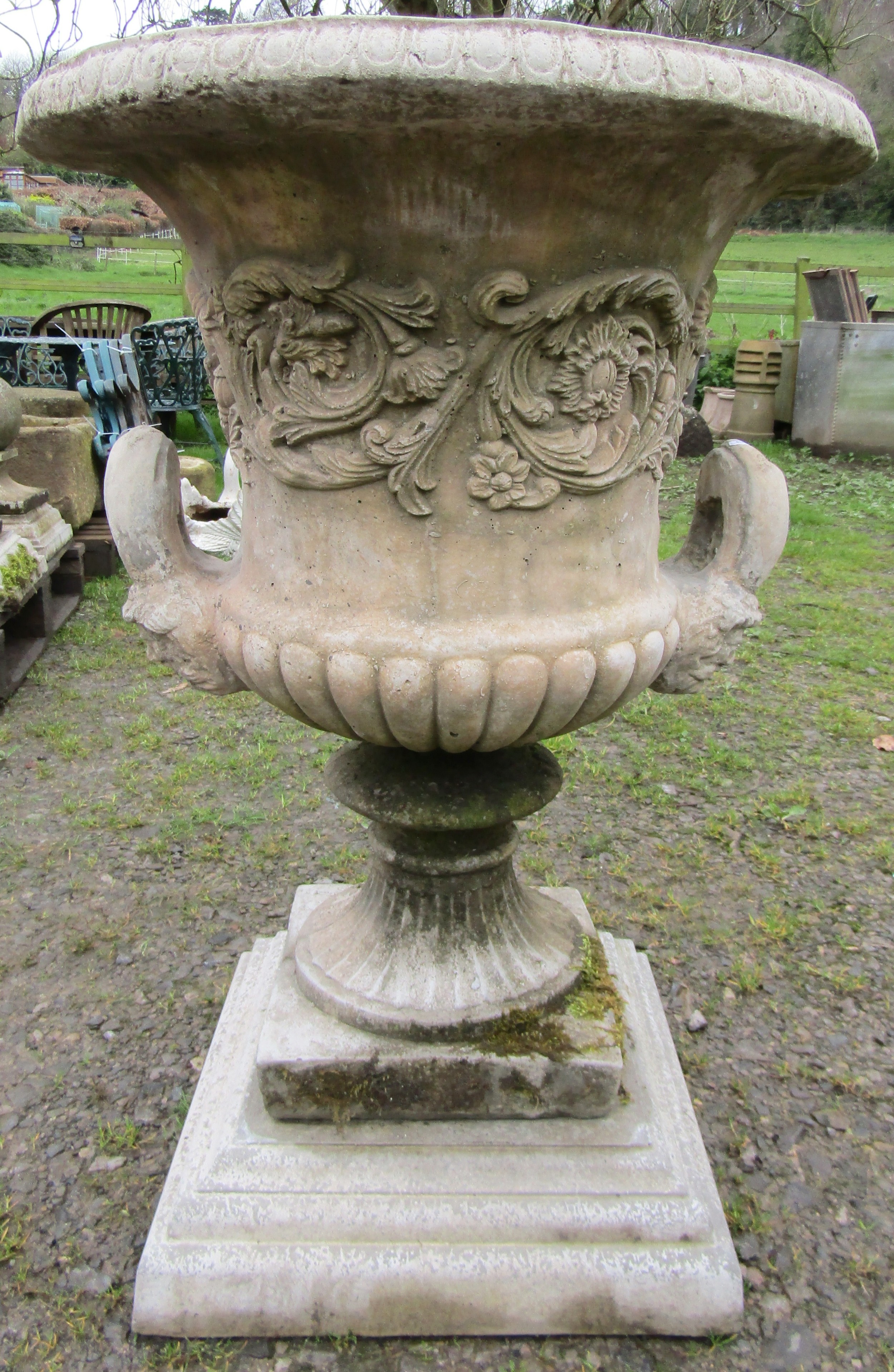 A large cast composition stone campana shaped garden urn with repeating scrolling foliate relief - Image 3 of 5